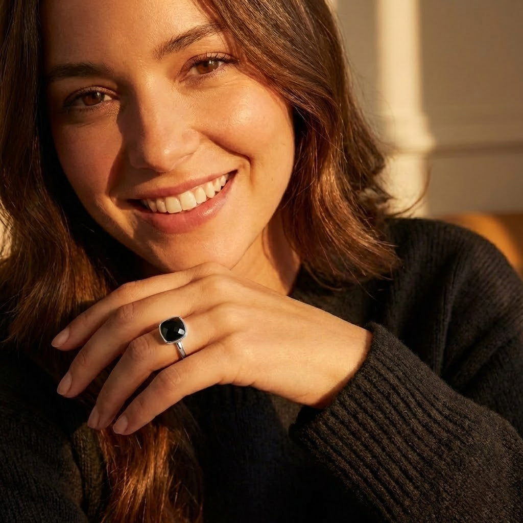 Faceted black onyx statement ring with cushion cut gemstone in smooth bezel setting, bold minimalist gold ring for women, modern cocktail ring style, handcrafted fine jewelry by Danique Jewelry