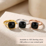 Gold black onyx ring on neutral background, faceted square gemstone ring, bold yet minimal jewelry piece, available in sterling silver and gold finishes, contemporary fine jewelry