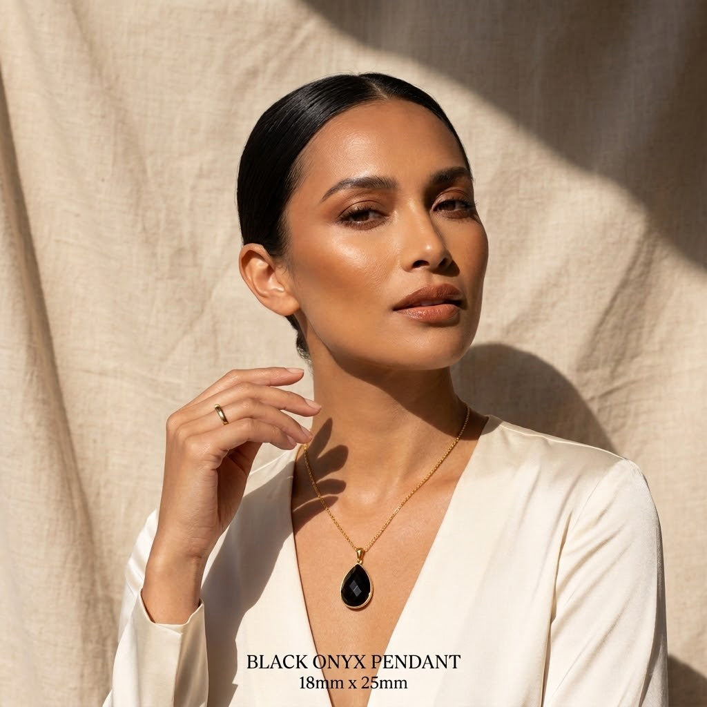 Model wearing black onyx teardrop pendant necklace in gold vermeil, elegant black gemstone necklace for women, minimalist dainty onyx jewelry, timeless statement pendant, gift for her, everyday black stone necklace for layering, refined modern jewelry styling for weddings, anniversaries, birthdays, or chic capsule wardrobe looks