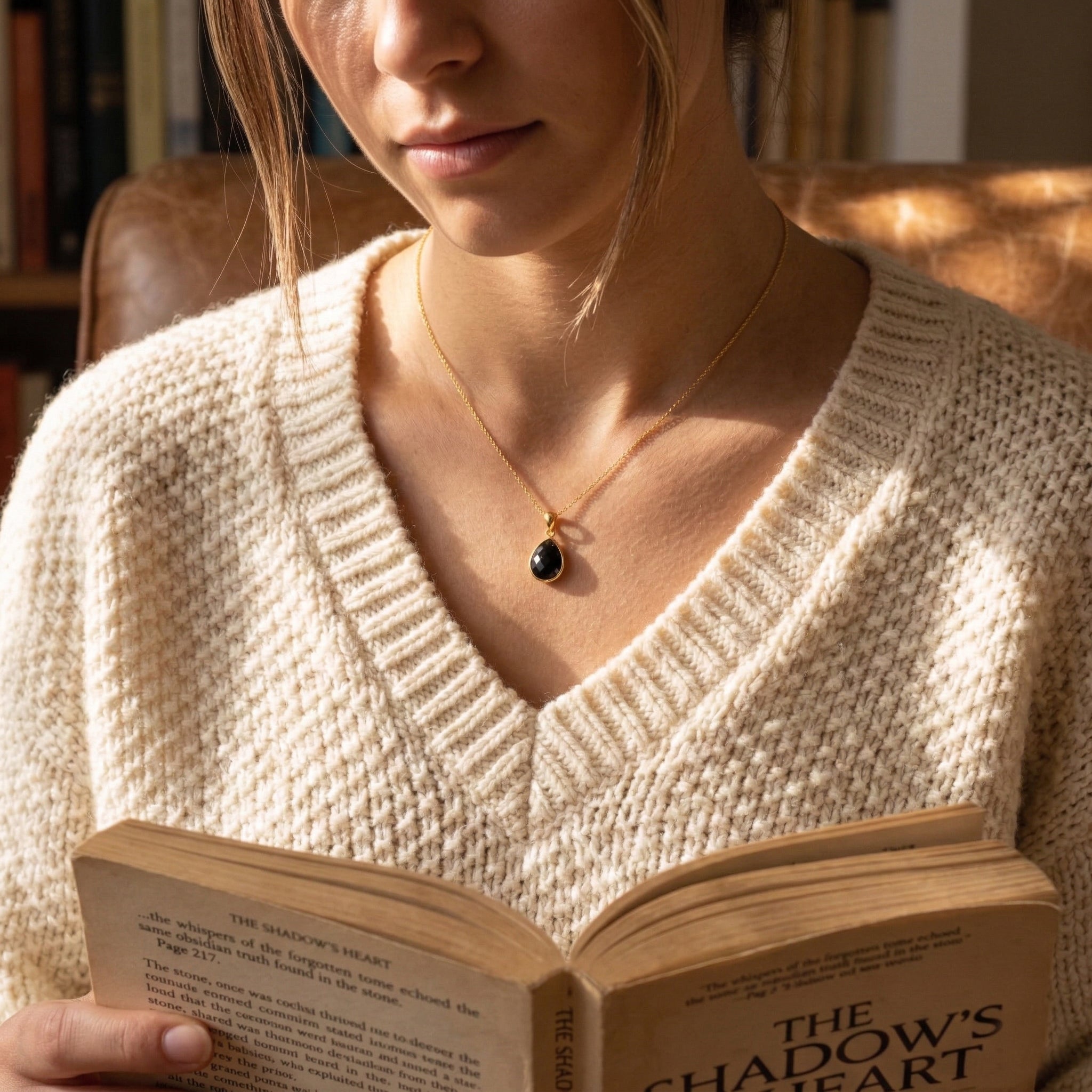 Woman wearing black onyx pendant necklace in gold vermeil, dainty teardrop black stone necklace for women, minimalist black gemstone jewelry, elegant everyday necklace, gift for her, small black onyx pendant for layering, timeless statement necklace with refined modern styling, meaningful gemstone jewelry for birthdays, anniversaries, bridesmaids, or holiday gifting