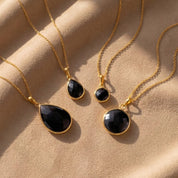 Black onyx necklace collection in gold vermeil showing round and teardrop pendant styles, dainty black gemstone necklaces for women, minimalist black stone jewelry, elegant everyday onyx pendant necklace, gift for her, layering necklace in yellow gold, sterling silver, or rose gold, modern black gemstone jewelry for weddings, anniversaries, birthdays, and classic capsule wardrobe styling