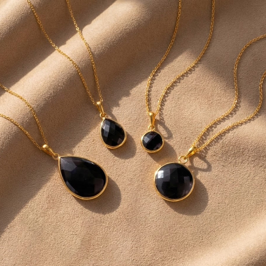 Black onyx necklace collection in gold vermeil showing round and teardrop pendant styles, dainty black gemstone necklaces for women, minimalist black stone jewelry, elegant everyday onyx pendant necklace, gift for her, layering necklace in yellow gold, sterling silver, or rose gold, modern black gemstone jewelry for weddings, anniversaries, birthdays, and classic capsule wardrobe styling