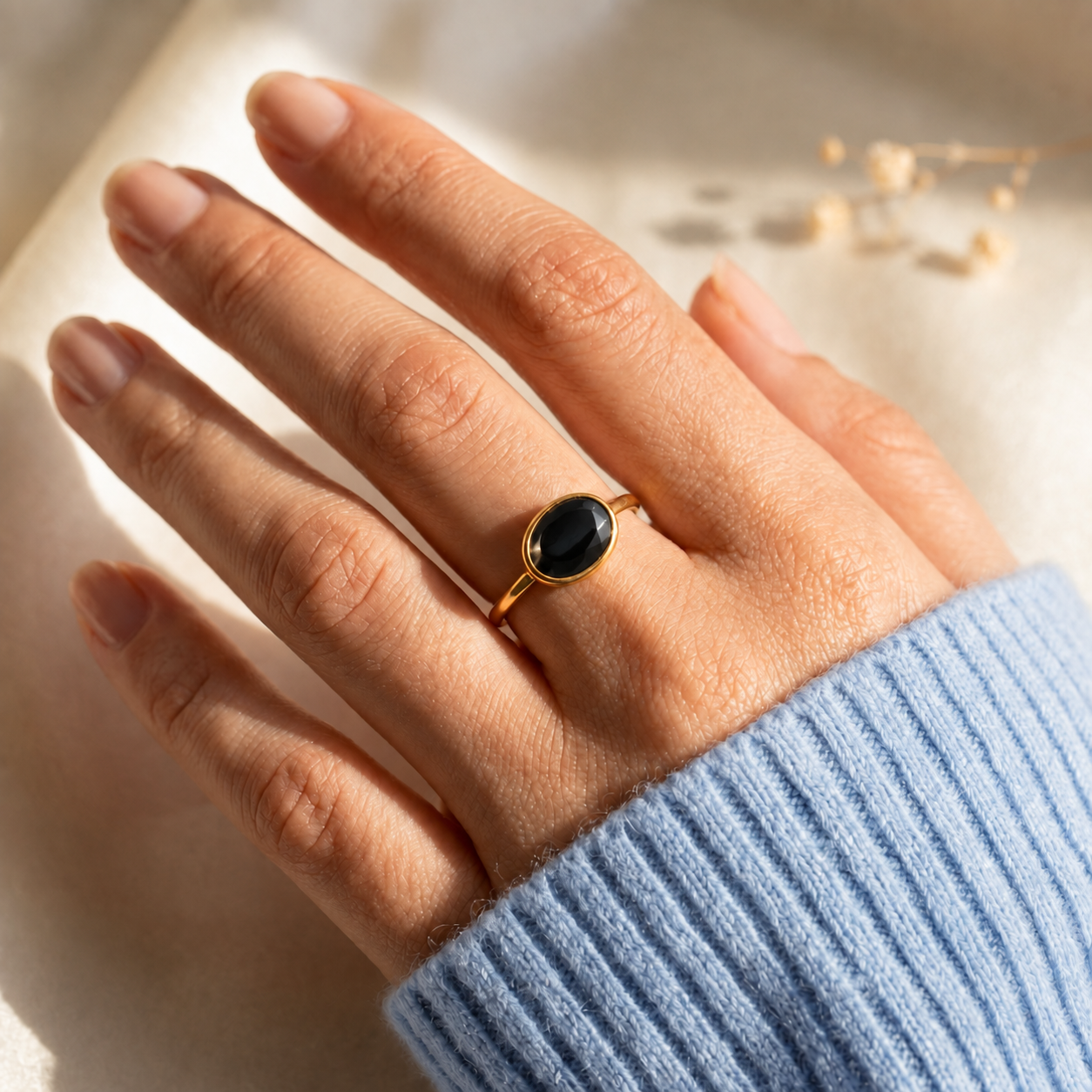 Small oval black onyx gemstone ring for women in minimalist bezel setting