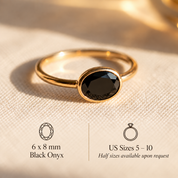 Black onyx oval bezel ring with slim stackable gold band