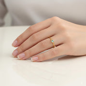 march birthstone aqua chalcedony ring worn on a woman’s hand, showing the slim minimalist band and bezel-set gemstone that stacks beautifully with other dainty rings, crafted in sterling silver or gold vermeil, perfect for everyday wear, personalized birthstone stacks, or meaningful gifts for mom, daughter, sister or best friend, soft natural light emphasizes the calming blue-green hues of the chalcedony stone and the delicate handcrafted design