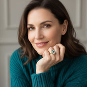 woman wearing blue topaz cushion cut gemstone ring, dainty aquamarine birthstone ring jewelry styling