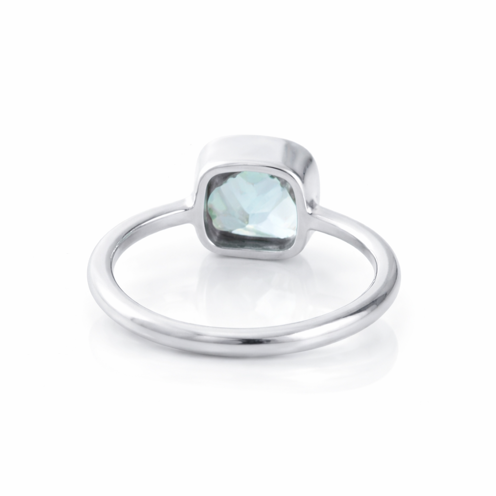 sterling silver blue topaz cushion cut ring on white background, bezel set aquamarine gemstone minimalist ring