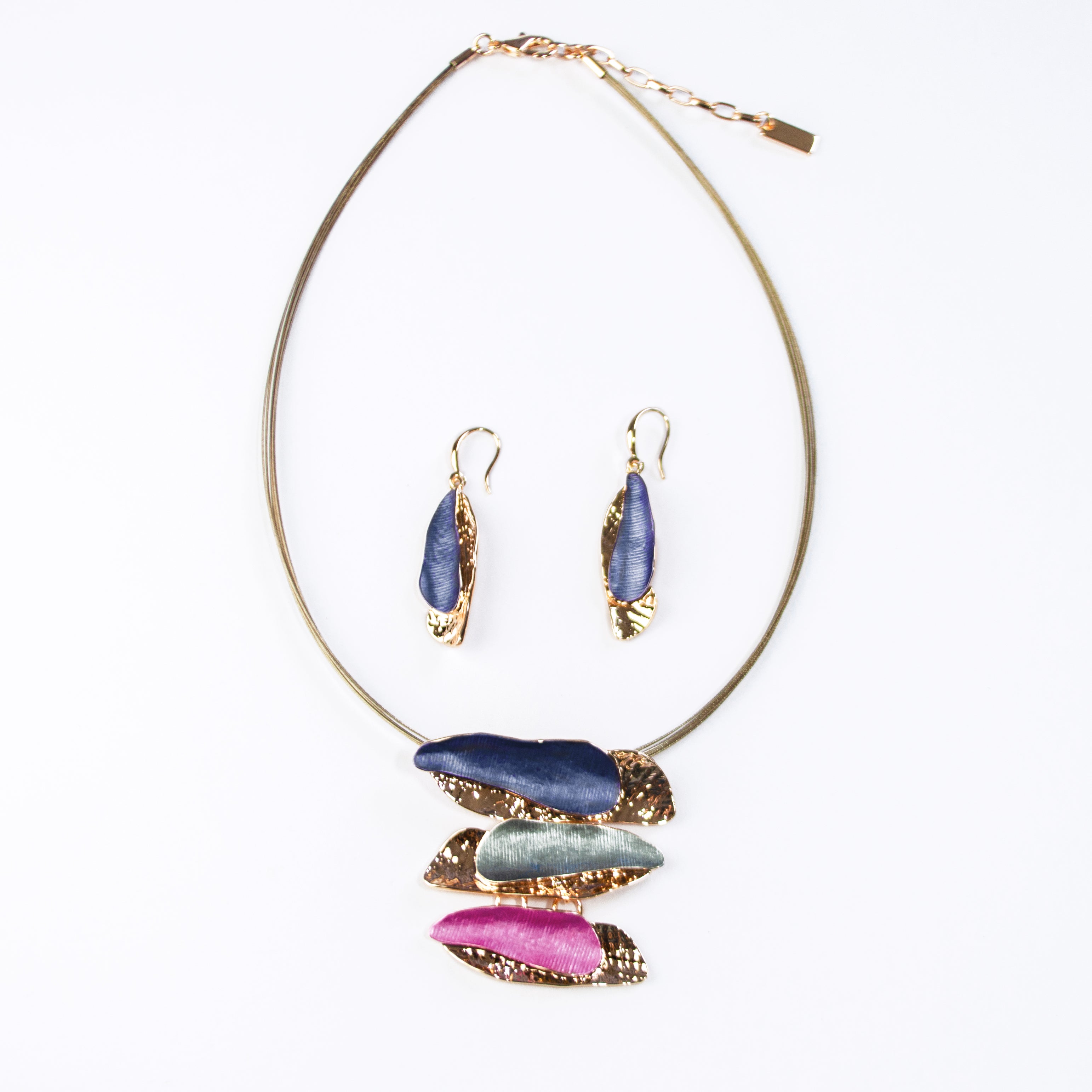 Adjustable Necklace with a steel wire chain and a rose gold plated pendant made of three organic bar shapes painted in enamel of either purple, gray, or pink. Necklace sits against a white background with matching earrings in purple and rose gold.