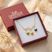 Personalized family tree necklace displayed in Danique Jewelry signature gift-ready packaging.