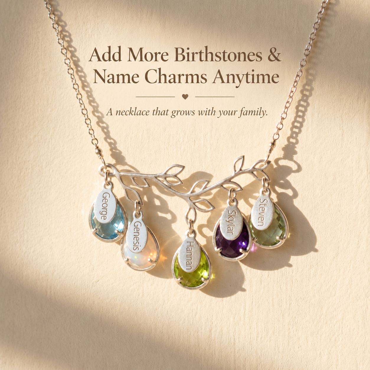Personalized family tree necklace with multiple birthstones and name charms showing that more family charms can be added later.