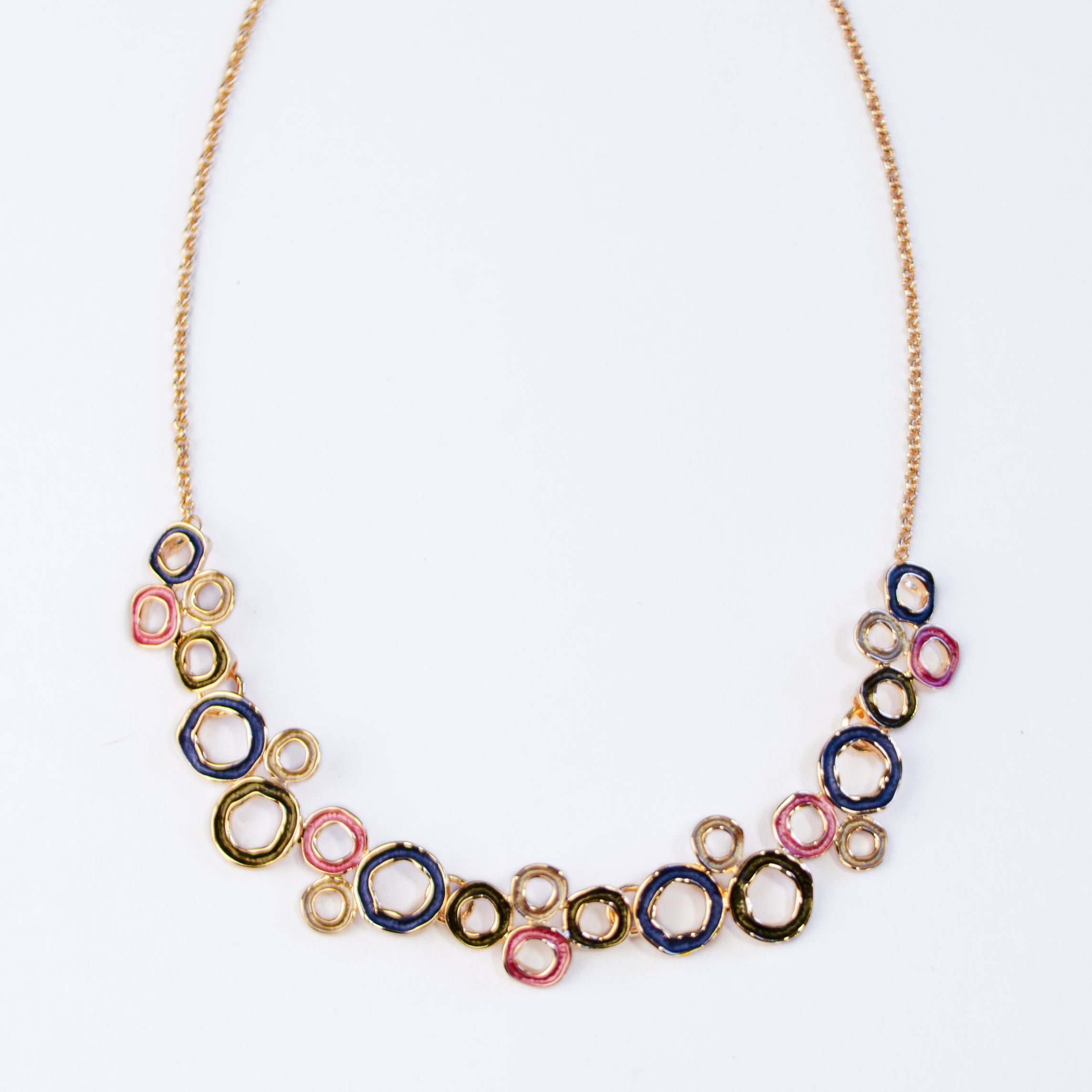 A gold necklace with a chain and a pendant made of multiple interconnected hand painted circles on white background. connected circles, adjustable necklace, zinc alloy, push back earrings, stud earrings, geometric jewelry, geometric necklace, statement necklace, boho jewelry, boho necklace, bohemian jewelry, bohemian necklace, mother's day gift for her, christmas gift, custom jewelry, valentine's day gift, birthday gift for mom, gift for her, nature inspired jewelry, fashion jewelry, gold