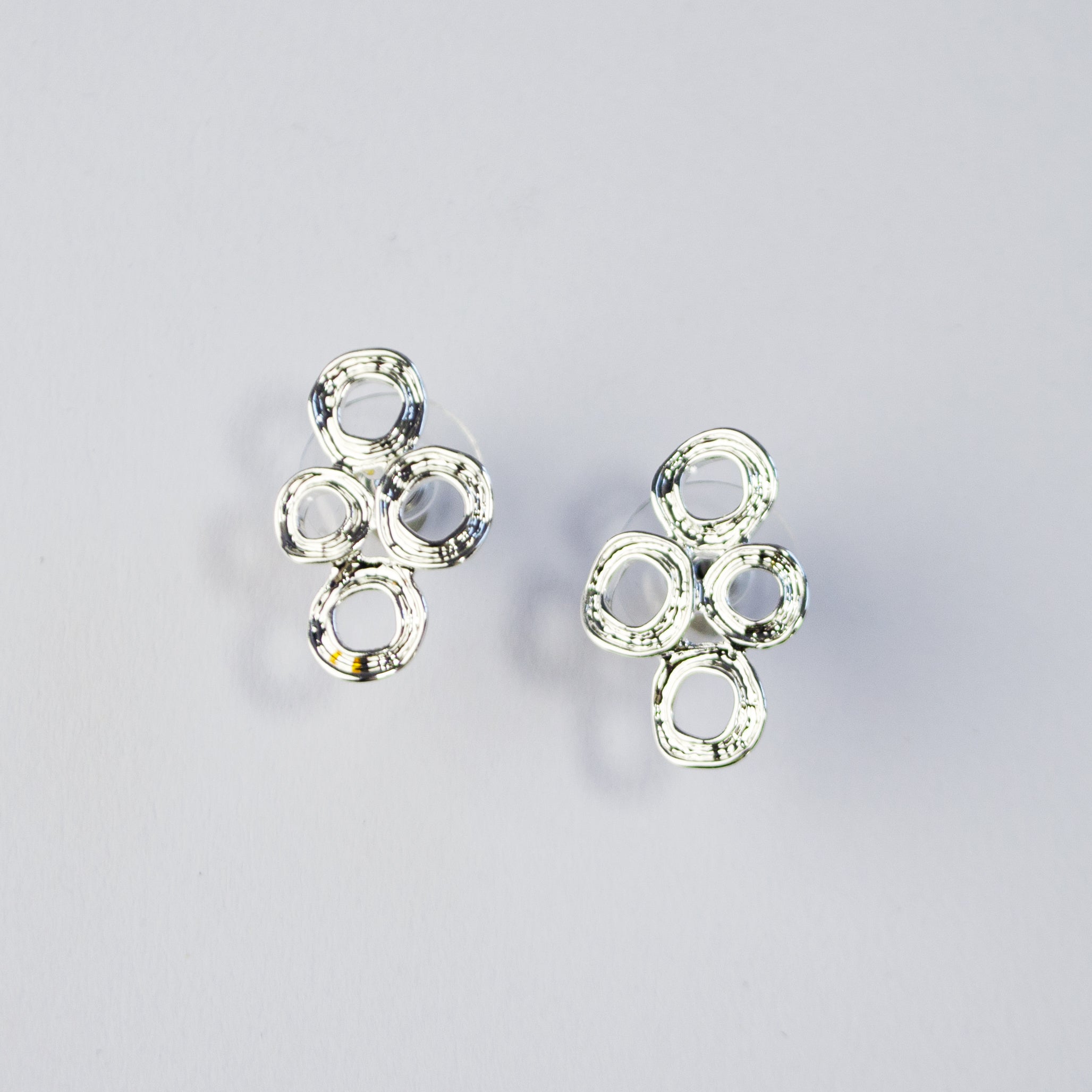 Abstract boho style silver double circle statement earrings, jewelry for summer, summer vacation fashion, statement geometric pendant, jewelry to wear to anniversary dinner, date night jewelry, artsy standout jewelry, silver stud earrings, gold stud earrings, boho earring collection