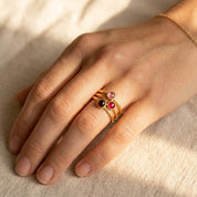 Custom birthstone ring worn on hand with two colorful gemstone rings, a meaningful family birthstone jewelry gift.