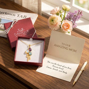 Gift-ready mom birthstone necklace with engraved name charms in a Danique Jewelry gift box.