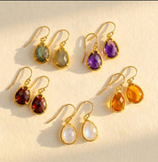 gold birthstone necklace and earrings set with teardrop stones representing kids and loved ones