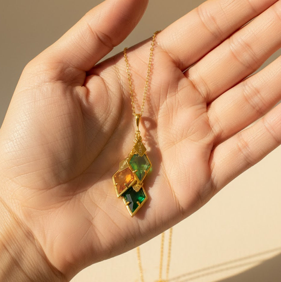 Close up of personalized birthstone necklace for mom with engraved name charms and colorful gemstone pendants, custom family jewelry gift with children's birthstones