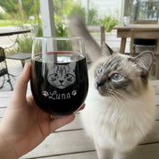 Custom cat portrait wine glass engraved with pet name Luna, shown beside a cat as a personalized pet glass.