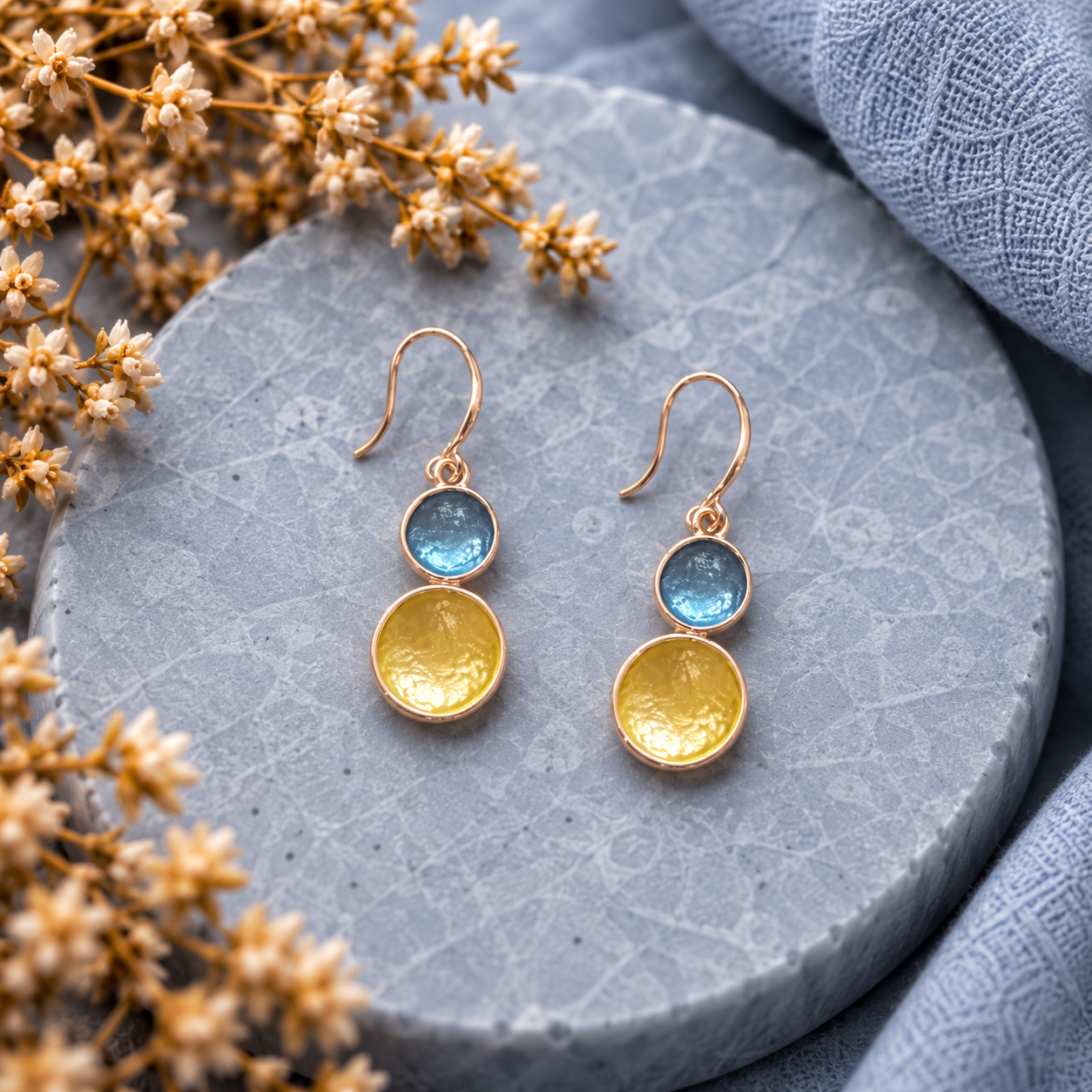 Sea Glass Glow Floating Circles drop earrings with blue and gold layered round charms on gray stone
