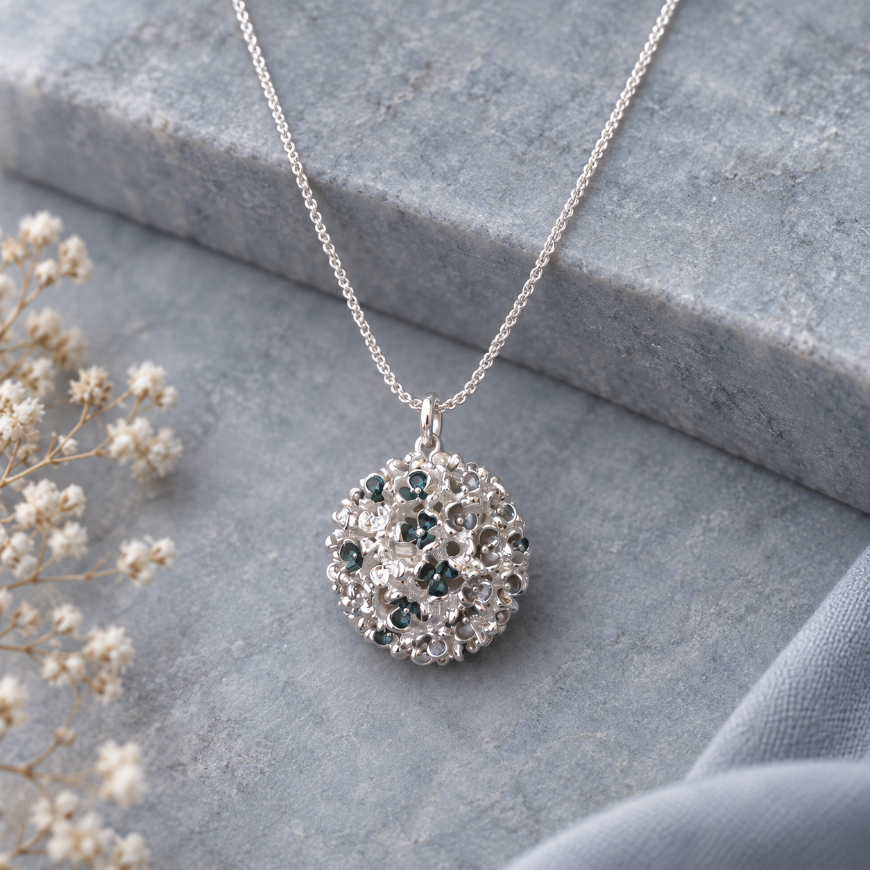 Close up of Constellation Orb sculptural pendant necklace with dimensional openwork design


