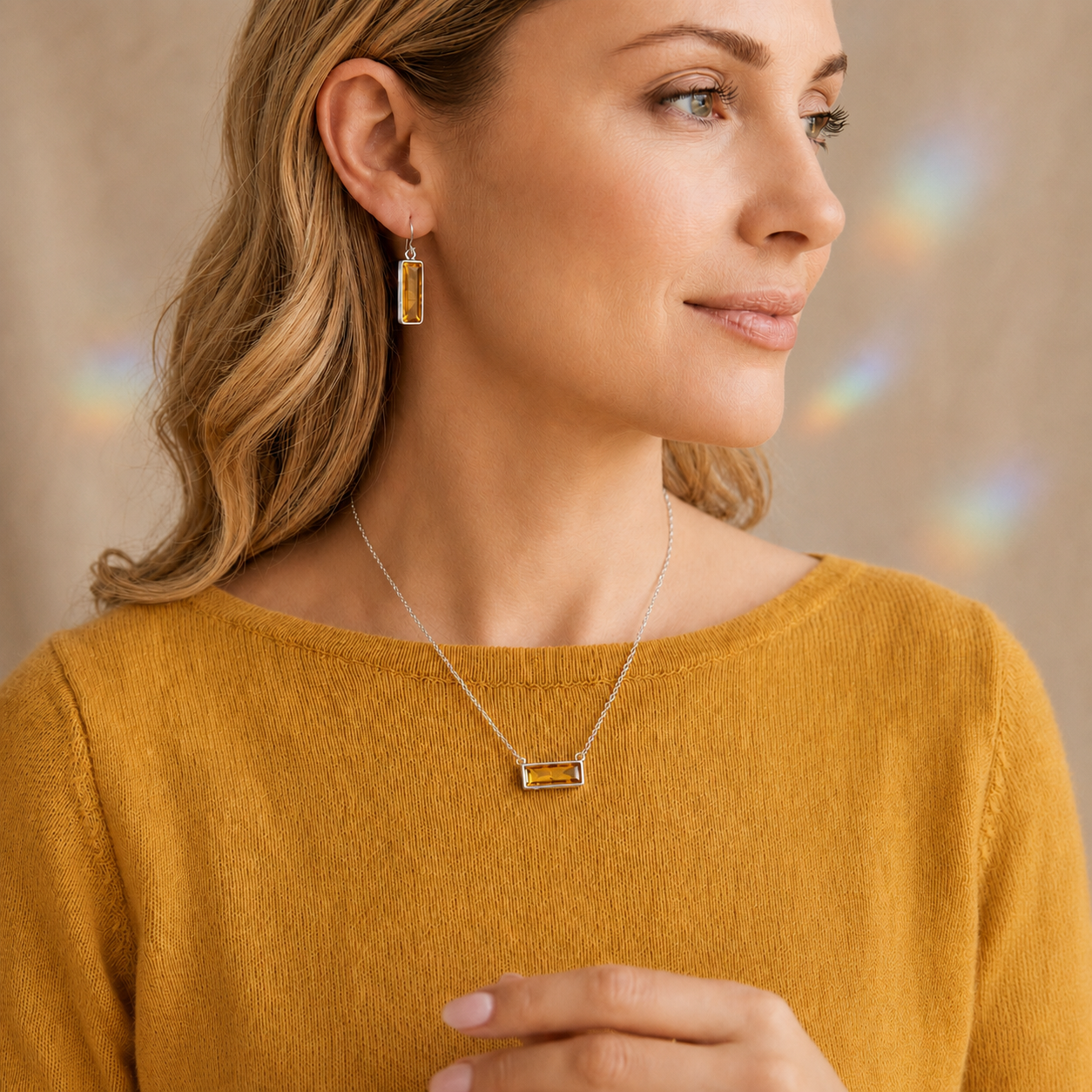 Blonde woman wearing Citrine Quartz earrings and a matching bar necklace