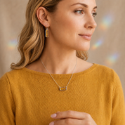 Blonde woman wearing Citrine Quartz earrings and a matching bar necklace