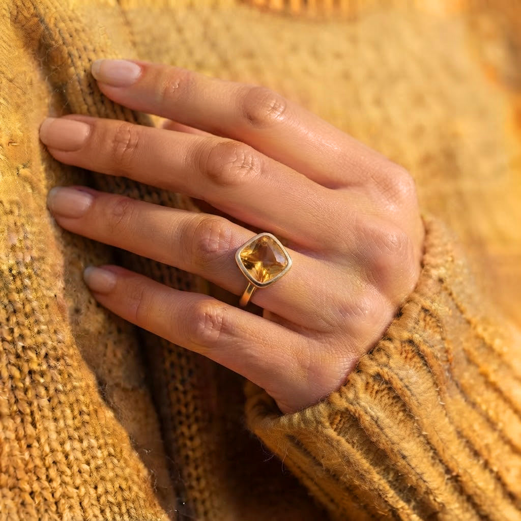 Model wearing a dainty gold vermeil citrine birthstone ring