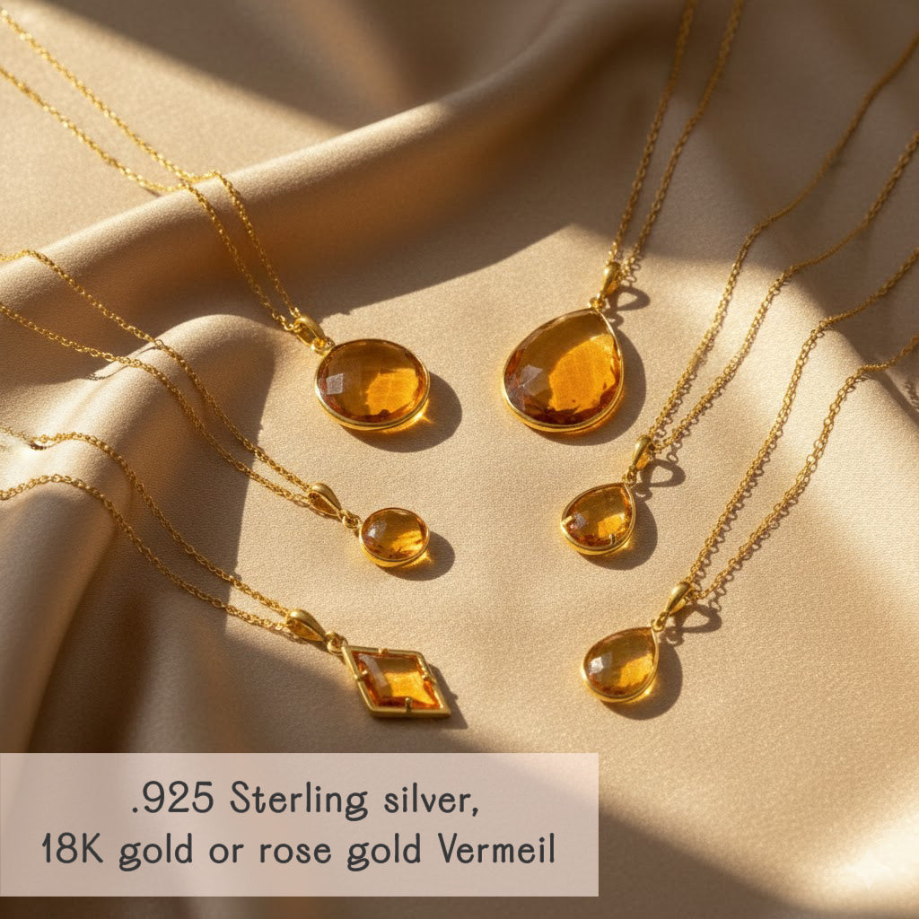 Citrine teardrop pendant necklaces styled on satin background with gold vermeil and sterling silver finishes, personalized November birthstone jewelry, minimalist gemstone necklace layering.