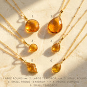 Shop our citrine necklace collection available in large, medium and small teardrops, prong set teardrop, prong set diamond, large and medium rounds on white background. Choose from satellite or cable chain. November birthstone. 