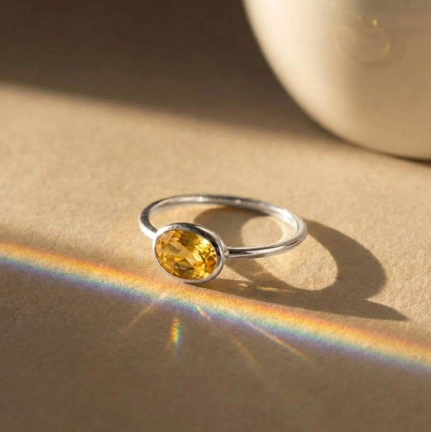Small oval citrine ring shown in sterling silver, yellow gold, and rose gold vermeil, highlighting November birthstone jewelry options.