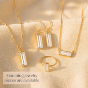 Matching Adira clear quartz jewelry pieces including earrings, necklaces, and ring in yellow gold vermeil.