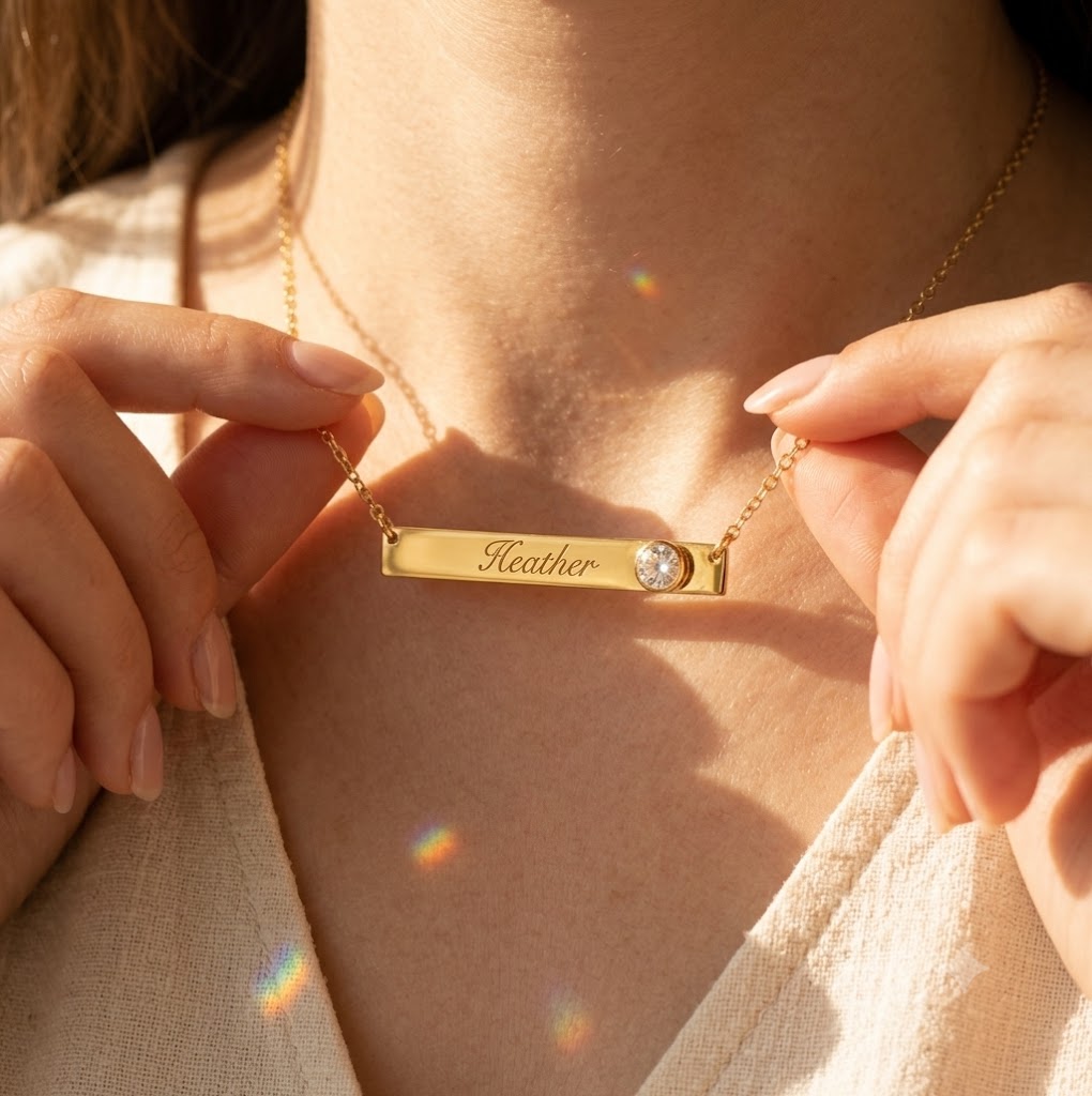 Personalized clear quartz bar necklace with engraved name Heather shown on model