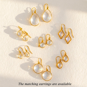 clear quartz dangle earrings close up bezel set gemstone