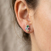 Tiny four birthstone cluster stud earring worn on the ear to show its delicate everyday size and colorful stones