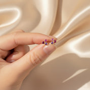 Delicate cluster birthstone bar stud earrings held between fingers to show scale, featuring bezel-set gemstones in .925 sterling silver or 18k gold vermeil. Dainty multi-stone design perfect for personalized birthday jewelry, mom gifts, bridesmaid accessories, or minimalist everyday earrings. A beautiful way to showcase meaningful birthstones through handcrafted artisan gemstone jewelry.