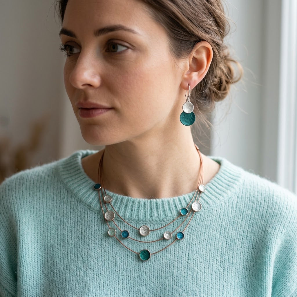 Woman wearing Teal Green and Silver double disc earrings with coordinating necklace
