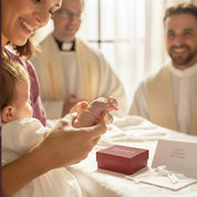 Personalized cross charm bracelet worn by a baby during a baptism ceremony, shown on infant’s wrist held by mother in a church setting. Custom engraved cross bracelet with delicate rosary-style chain, symbolic Christian jewelry gift for baptism, christening, dedication, or blessing. Meaningful keepsake gift for baby, godchild, goddaughter, or newborn, handcrafted in 925 sterling silver or 14k gold filled, presented in gift-ready jewelry box.