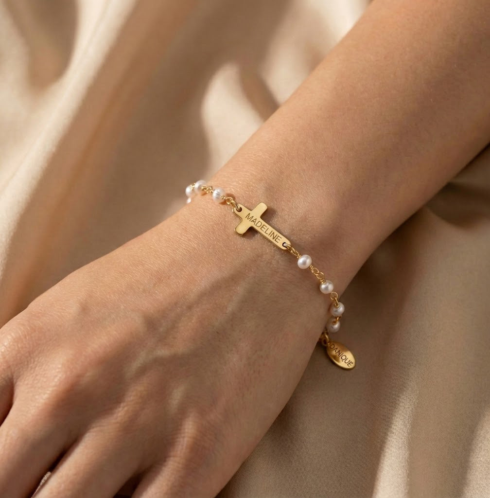 Gold cross bracelet with freshwater pearls shown on wrist, elegant religious jewelry gift for women. Perfect for baptism, confirmation, first communion, or christening. A meaningful keepsake for daughter, goddaughter, granddaughter, mom, or best friend. Thoughtful Catholic gift for birthdays, Christmas, Easter, or religious milestones. Dainty faith bracelet blends modern fashion with timeless spiritual symbolism, ideal for everyday wear or special occasions.