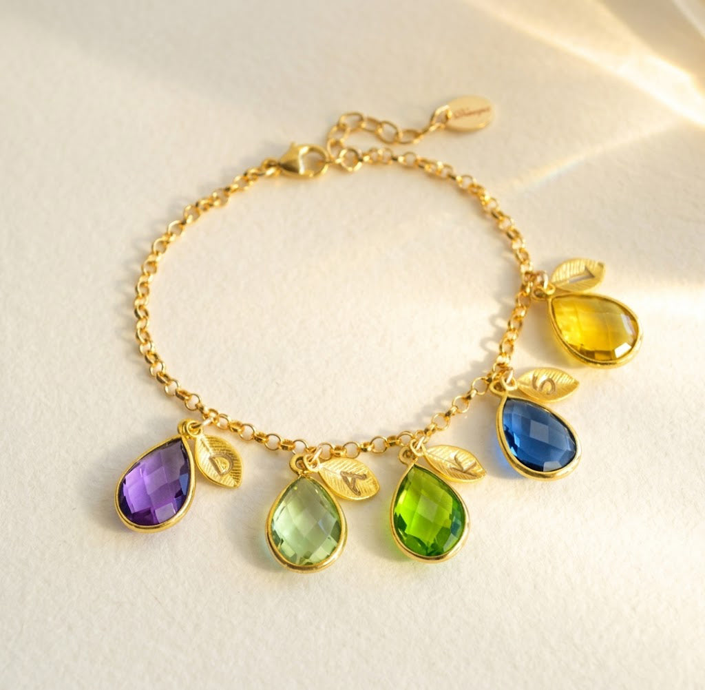 Custom birthstone and initial charm bracelet in gold with colorful teardrop gemstones, personalized family bracelet for mom