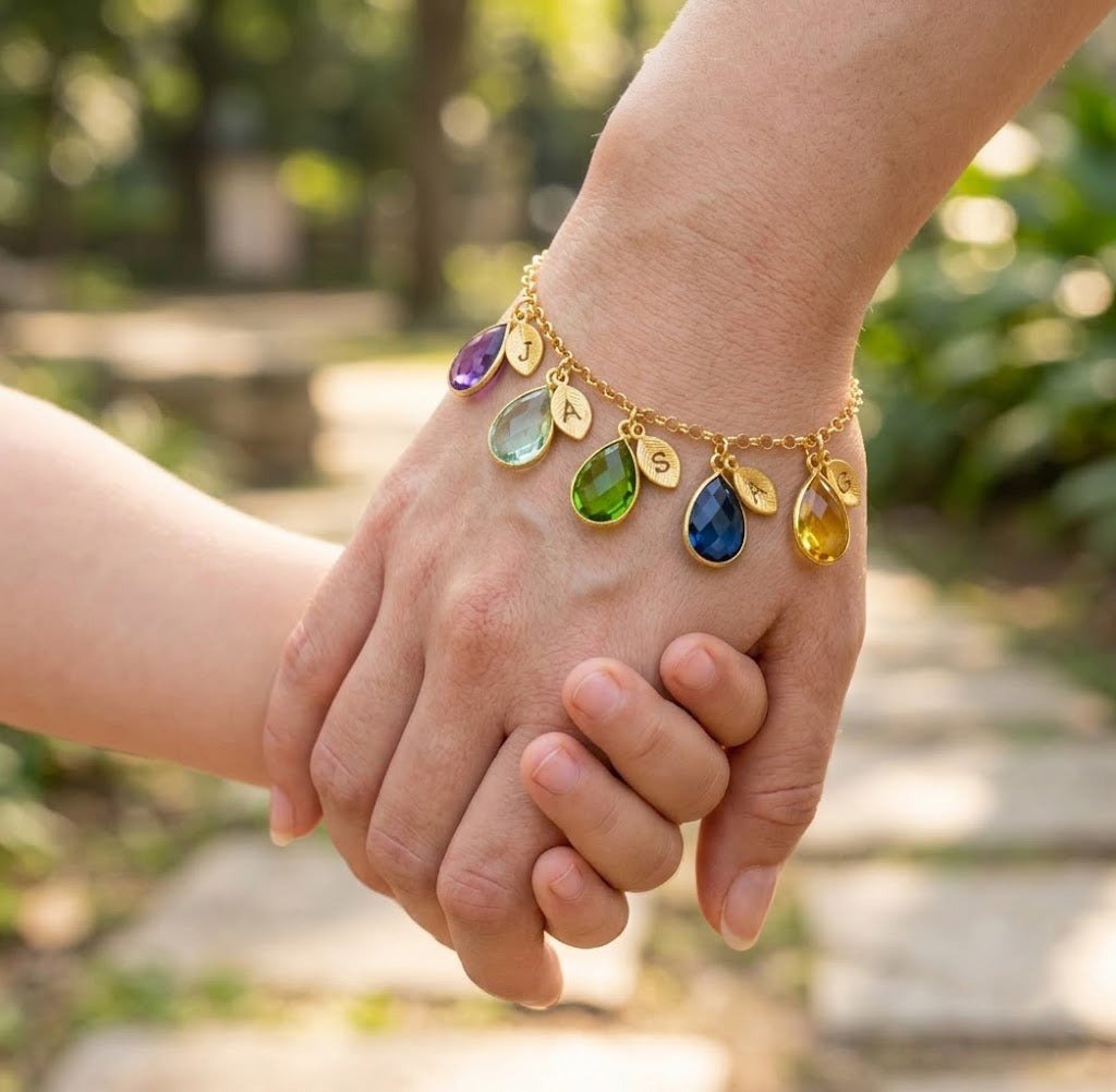 Woman wearing personalized birthstone and initial charm bracelet, custom family jewelry gift for mom or grandma