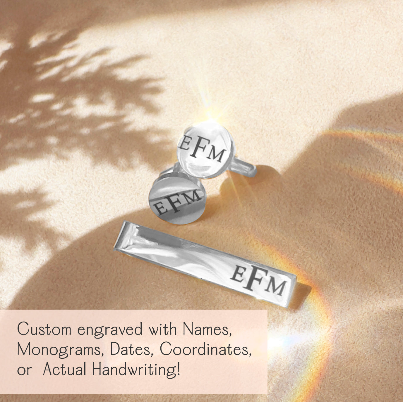 Personalized silver cufflinks and matching tie clip engraved with the monogram "EFM," displayed on a warm, golden fabric background with sunlight and shadows. This custom men’s accessory set can be engraved with names, monograms, initials, dates, coordinates, or actual handwriting for a meaningful and unique touch. Perfect gift for weddings, groomsmen, anniversaries, Father’s Day, graduations, retirements, and other milestone celebrations.