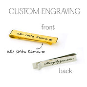 Custom engraving options shown on silver and gold tie clips, featuring names, coordinates, and special messages on front and back for a personalized keepsake gift for him.