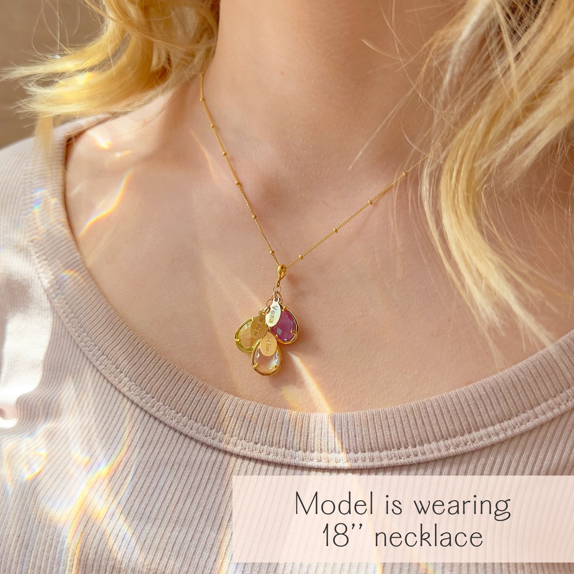 Personalized mother’s necklace with three teardrop birthstones and engraved name charms, worn at 18 inches on a gold-filled chain. This custom family jewelry piece makes a unique grandmother necklace with grandkids’ names, or a meaningful new mom gift. A thoughtful keepsake for milestone celebrations such as baby showers, anniversaries, or Mother’s Day, this dainty birthstone necklace is handcrafted in sterling silver or gold filled with 18k vermeil bezels.
