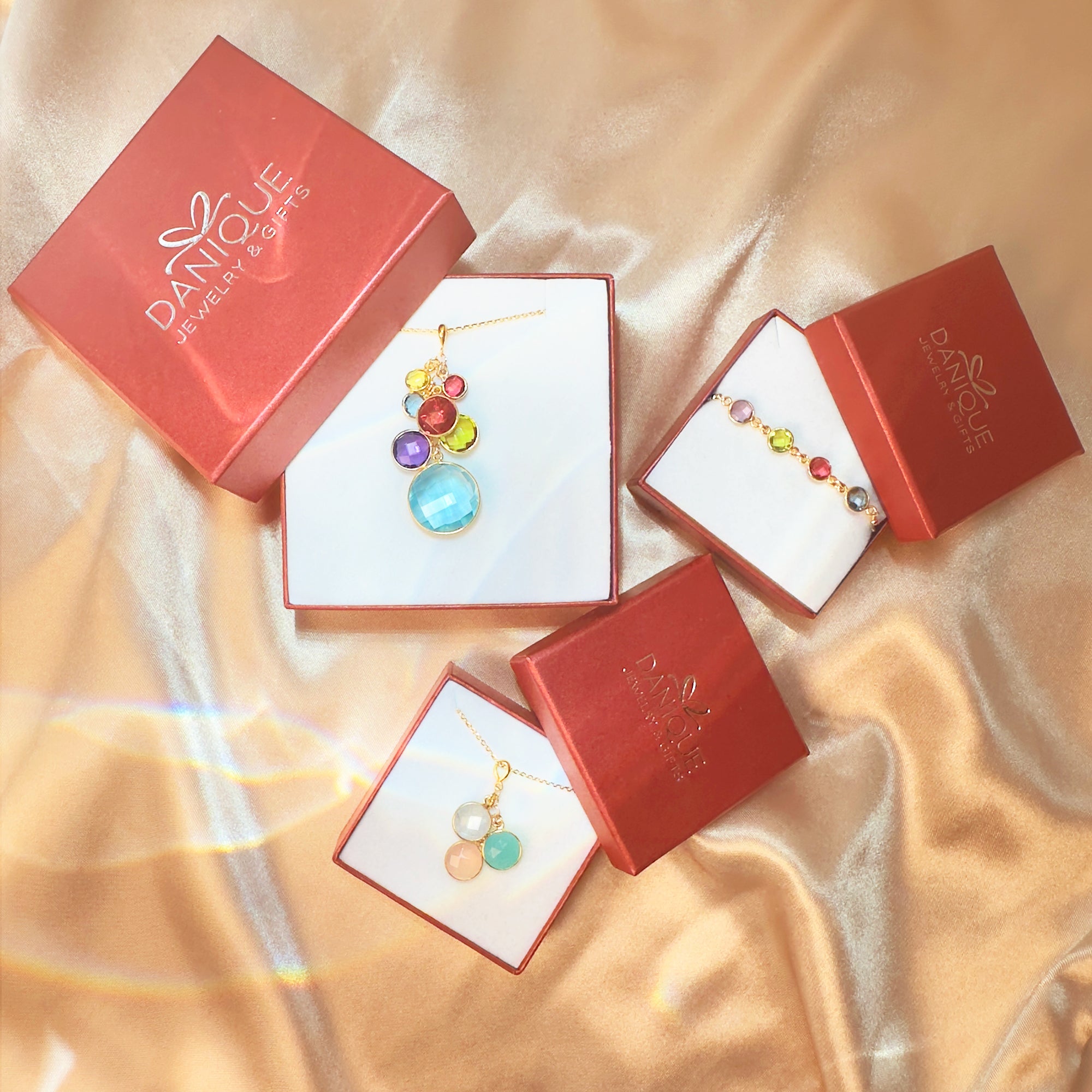 Danique Jewelry gift packaging with custom engraved footprint necklace, gemstone birthstone necklace, bracelet, and gold band ring in signature gift boxes. Perfect presentation for personalized footprint necklace, baby memorial jewelry, or new mom gift. Elegant jewelry gift box makes it ready for giving at baby showers, Mother’s Day, Christmas, birthdays, or anniversaries. High-quality packaging adds a special finishing touch, making your keepsake jewelry even more meaningful for mothers, grandmothers, or l