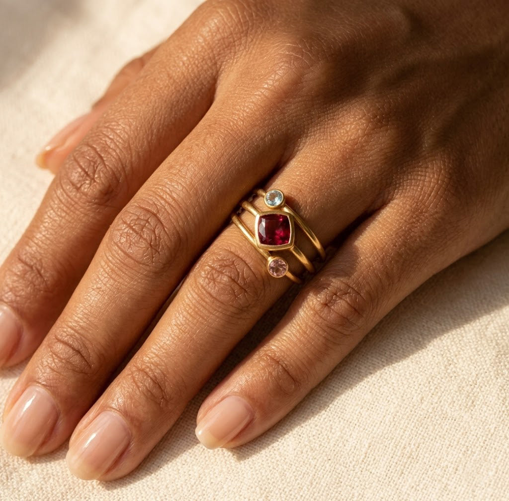 Woman wearing a custom birthstone ring set with colorful gemstones, designed as meaningful mom jewelry with stones for children or loved ones.
