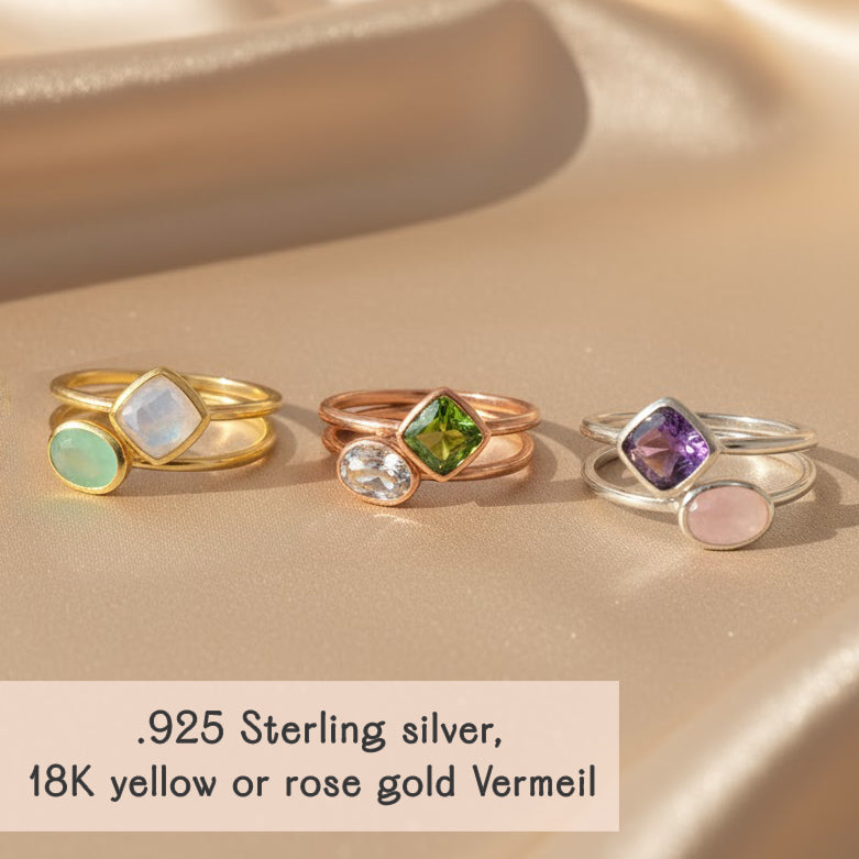 Close up of hand with birthstone rings in gold vermeil, oval and diamond shape bezel gemstone rings, minimalist stacking jewelry