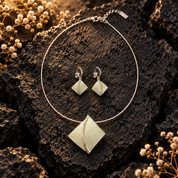 Soft Pearl sculpted leaf necklace and matching earrings with pearlescent abstract design on dark stone

