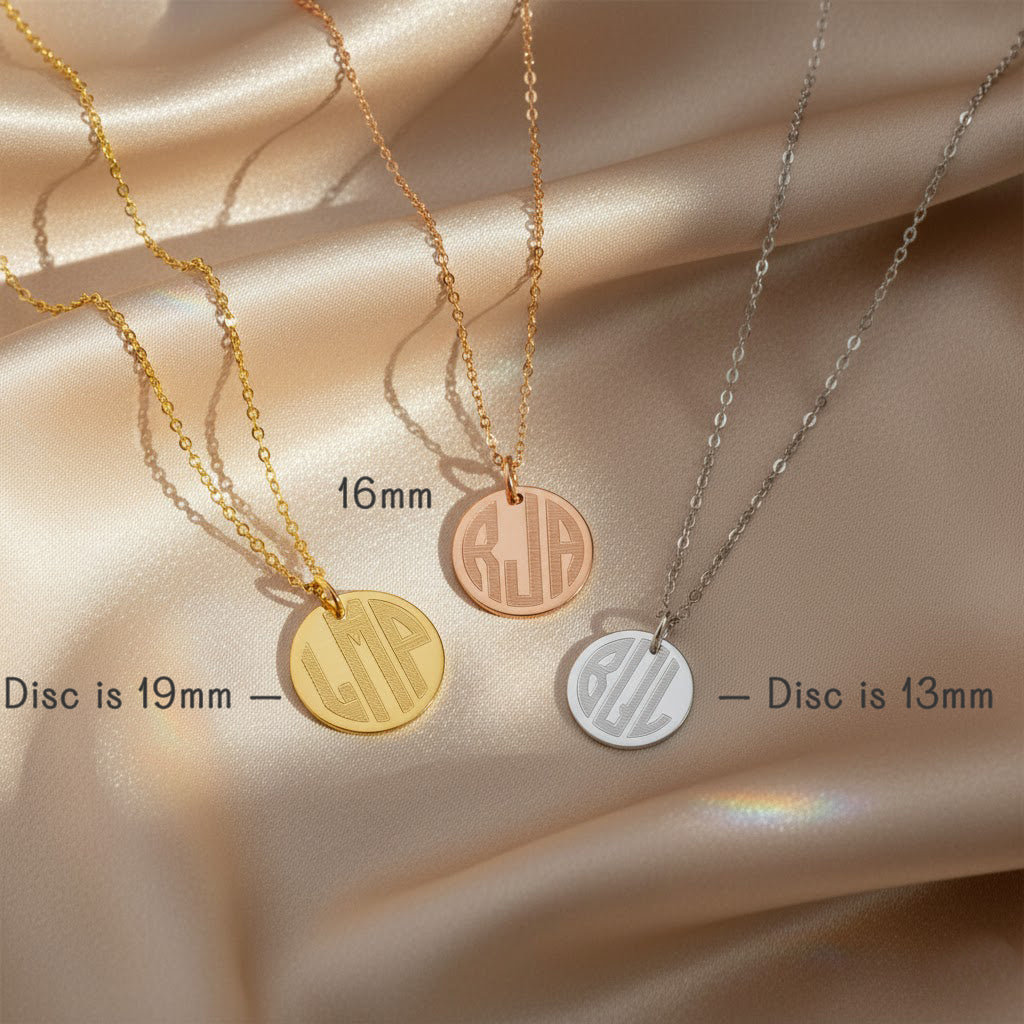 Gold, rose gold, and sterling silver monogram disc necklaces displayed on satin background, showing three pendant sizes (19mm, 16mm, 13mm) with engraved initials; size comparison image for custom engraved monogram pendant necklace, personalized gift for her.