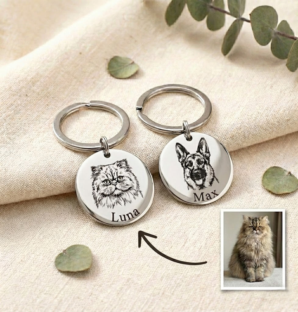 Custom pet portrait keychains engraved with detailed dog and cat illustrations and personalized pet names, displayed on soft neutral fabric with reference pet photo. Round stainless steel pet keychains created from customer photos, designed as meaningful keepsakes for pet parents. Personalized pet portrait keychain gift ideal for dog lovers, cat lovers, pet memorial jewelry, birthdays, or heartfelt remembrance gifts.