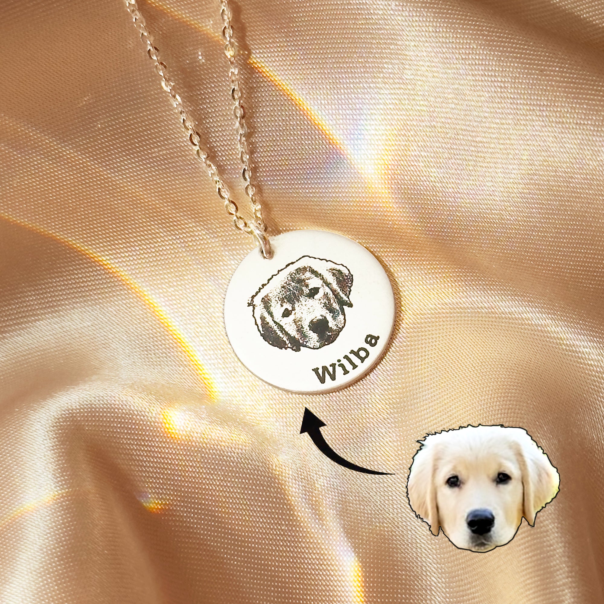 Warm, softly lit close-up of a dog portrait necklace engraved on a round disc with a tiny paw accent nearby. A sentimental pet keepsake and memorial keepsake jewelry piece; personalized dog memorial gifts for sympathy or remembrance; available in sterling silver, gold-filled, or rose gold-filled; optional birthstone charm and back engraving for names and dates.