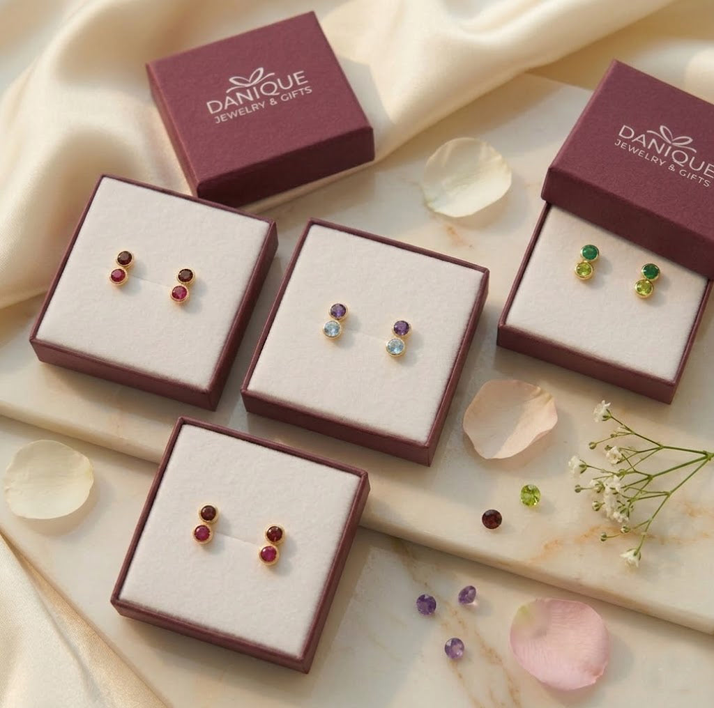 Gift-ready custom birthstone stud earrings displayed in Danique Jewelry boxes, personalized with one, two, or three birthstones in sterling silver or gold.